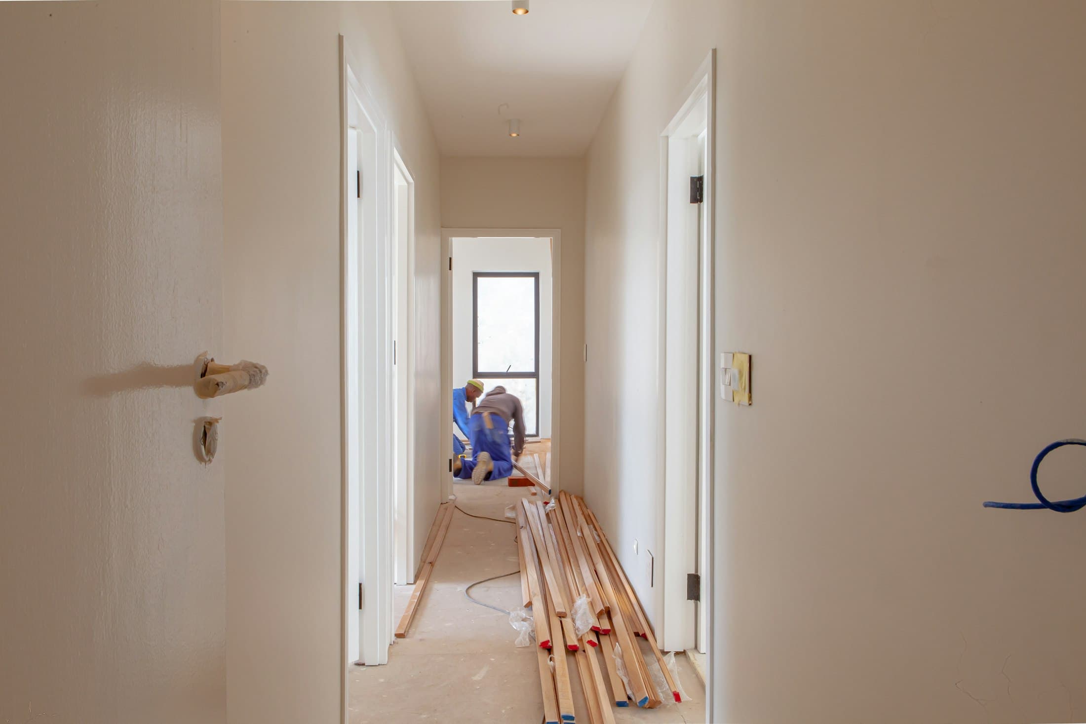 Two construction workers collaborating on a home renovation project