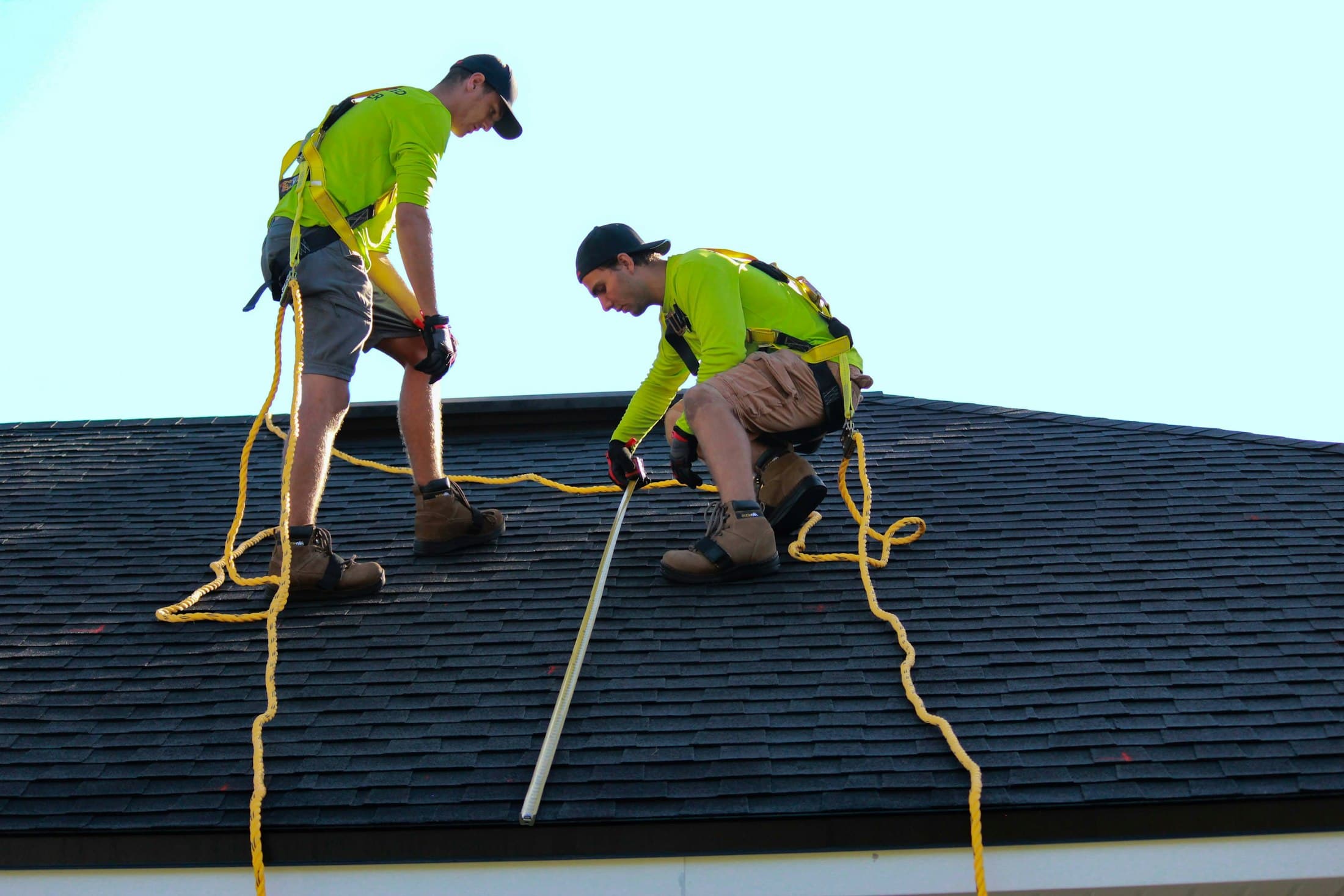 Workers positioned on a residential roof during installation