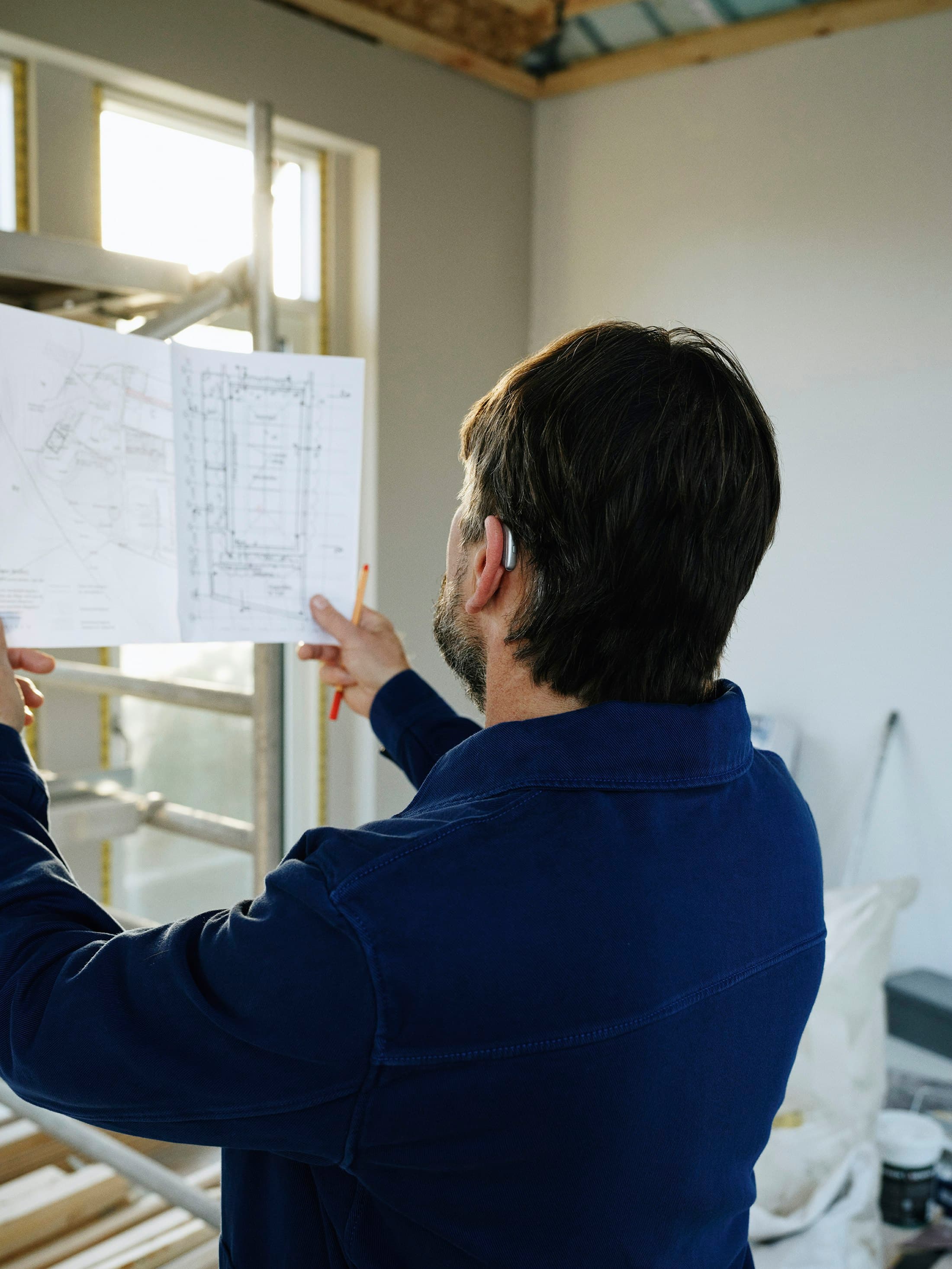 Contractor reviewing project plans on site