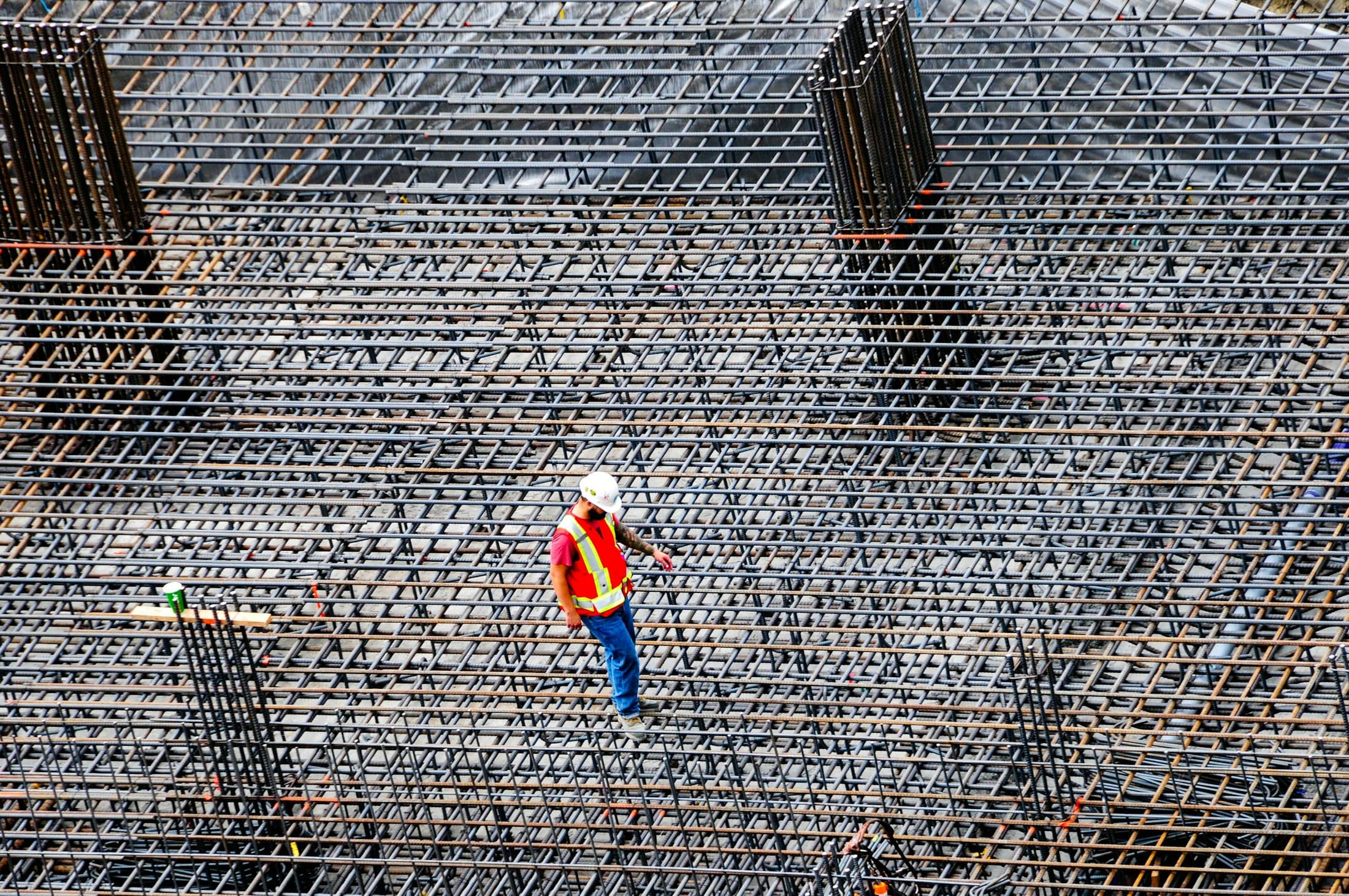 Contractor inspecting structural work on a building site