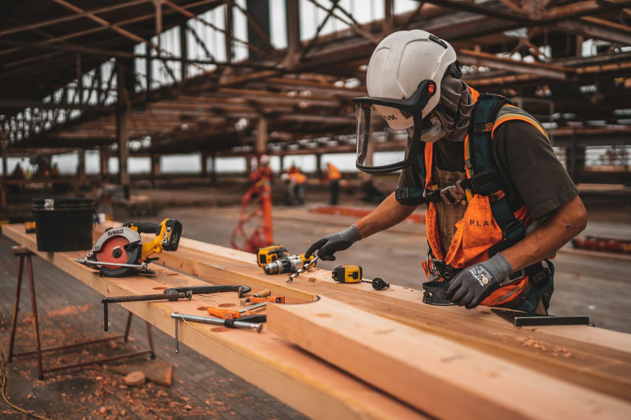 Construction worker holding a power tool on site